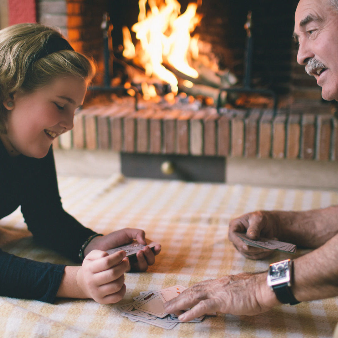 grandfather and granddaughter playing cards