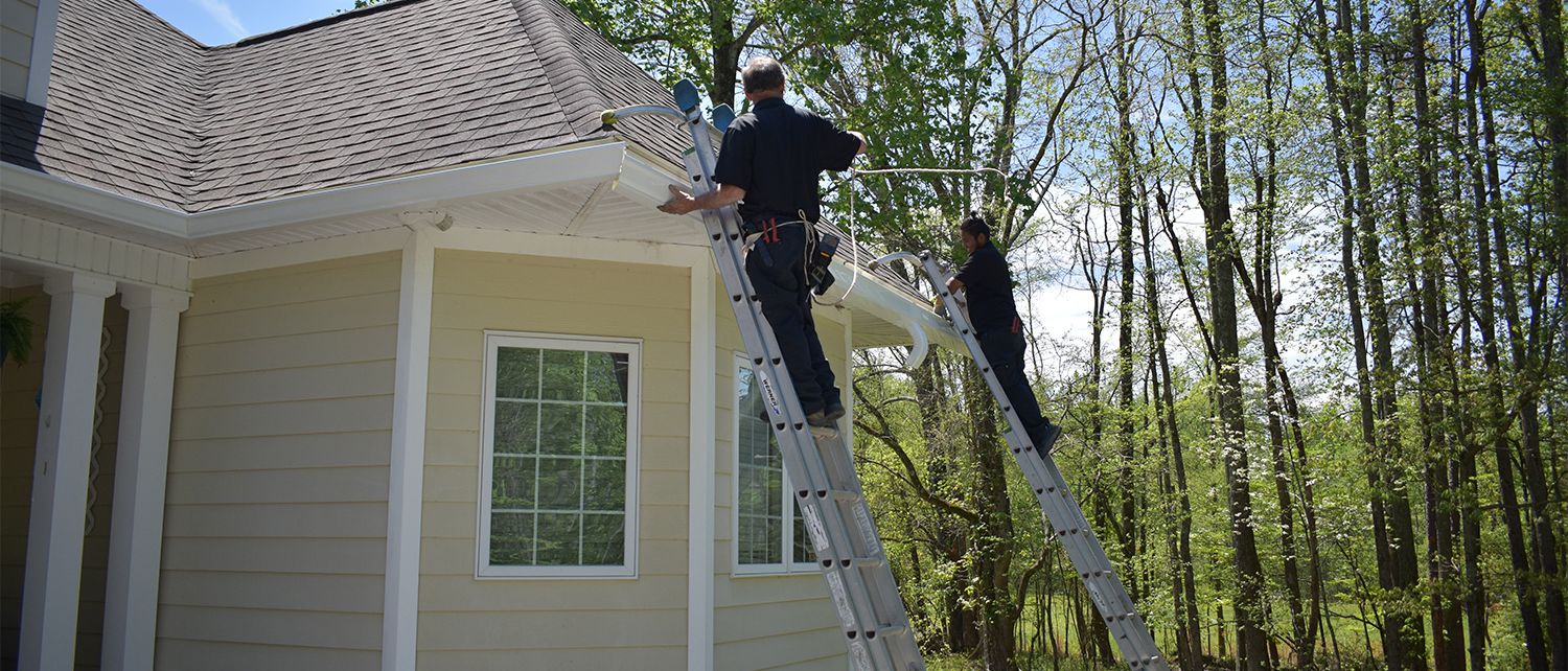 gutter repair with two men